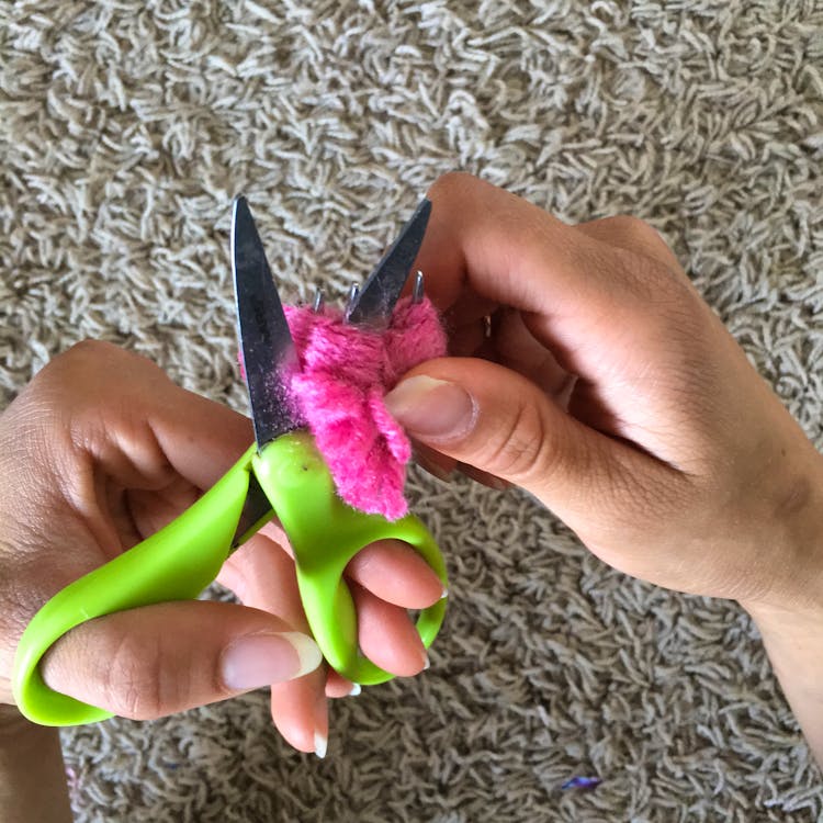 Scissors cutting the yarn on fork Scissors cutting the yarn on fork