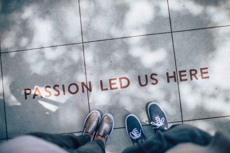 sign on ground saying passion led us here sign on ground saying passion led us here